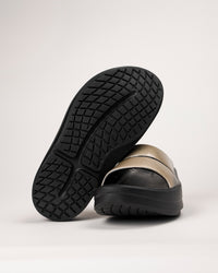Bottom view of the OOFOS Luxe Slide showing traction pattern