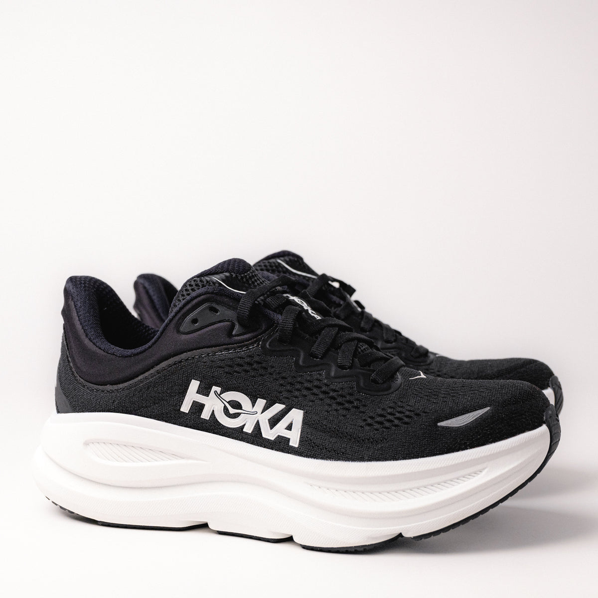 Side profile of Women's HOKA Bondi 9 Running Shoe in Black/White