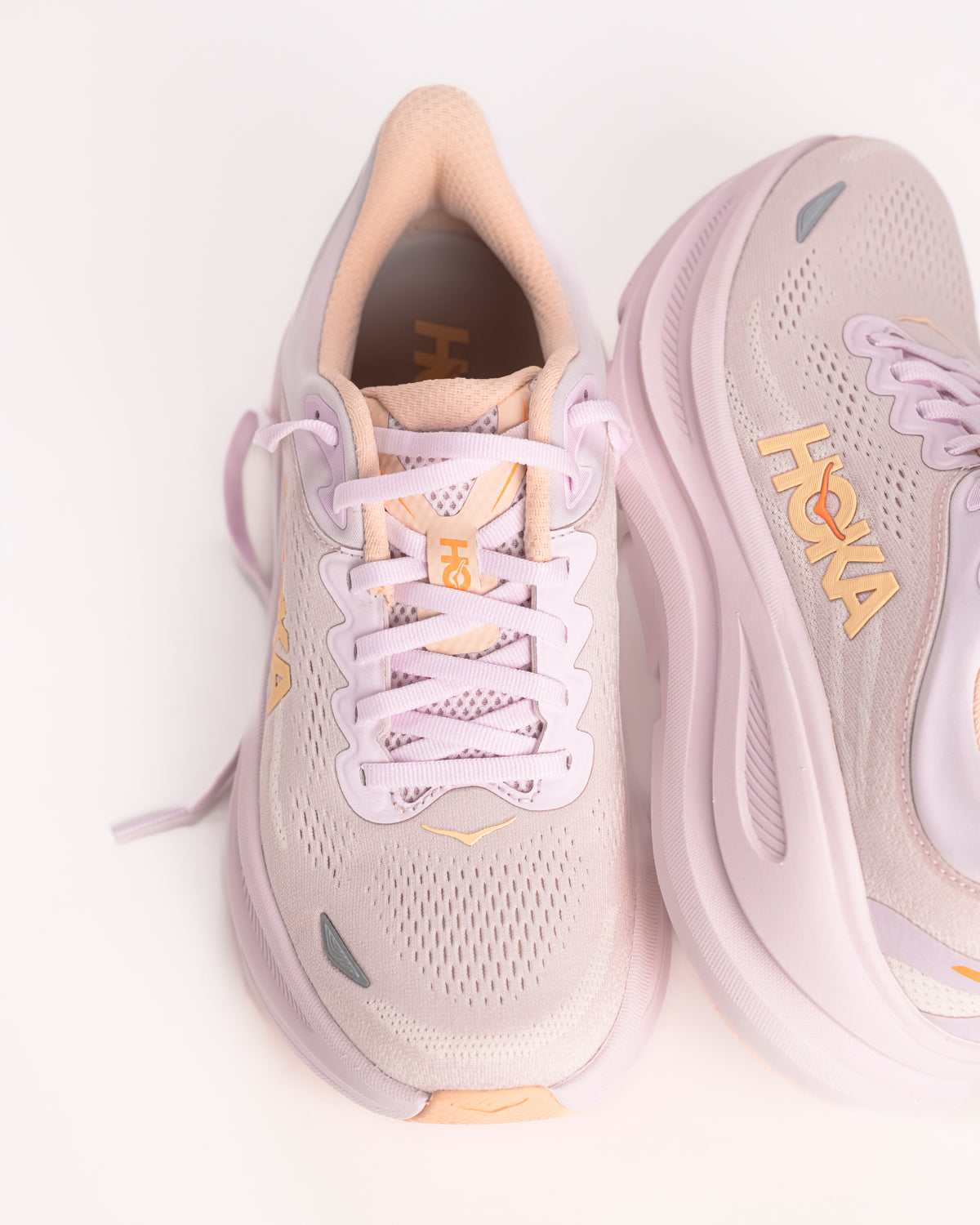 Women’s HOKA Bondi 9 – Max-Cushioned Running Shoe in Lilac Cream / Tangerine, Peachy Pink colorway with bright tangerine accents. 1162012-LRMT