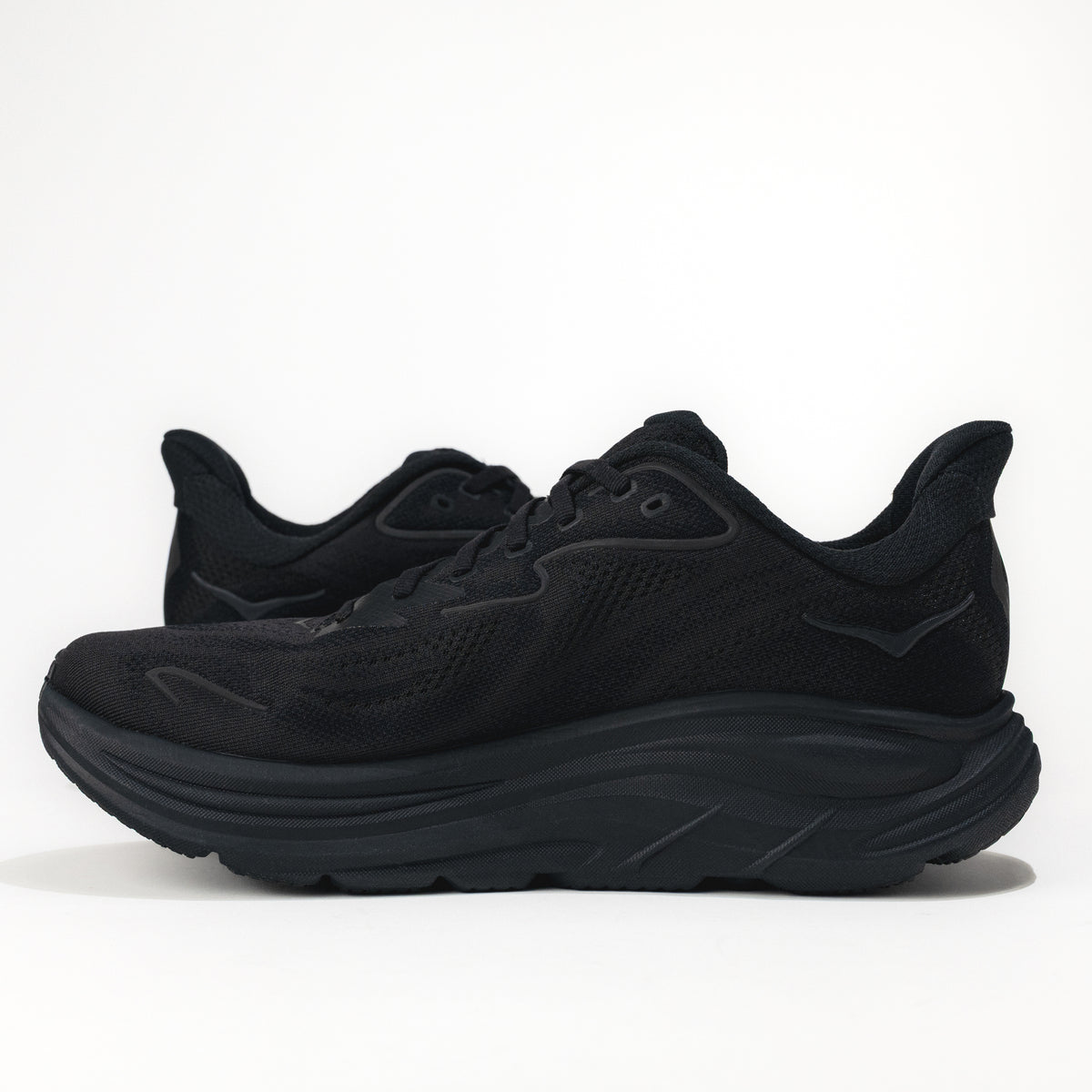 Black running shoes on a white background. 
Men's HOKA Clifton 10 Lightweight Running Shoe in All Black