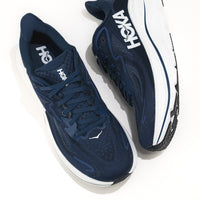 Navy running shoes with white soles and 'Hoka' branding on a white background.
Men's HOKA Clifton 10 Lightweight Running Shoe in Navy/White