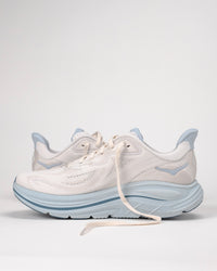 Off white and light blue HOKA Clifton 10 running shoes on a white background