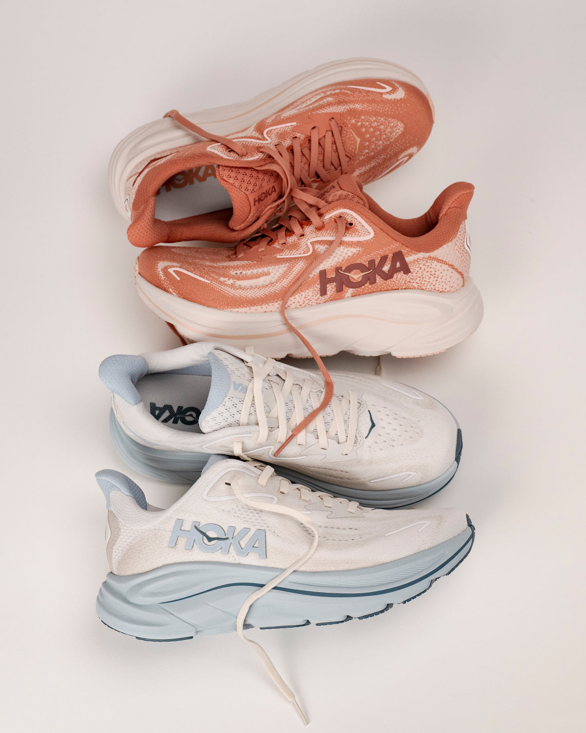 New colors of HOKA Clifton 10 running shoes for women stacked together on a white background