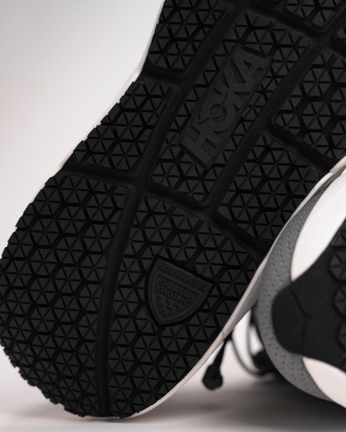 Outsole detail of HOKA Arahi SR with tacky non-marking oil & slip-resistant traction pattern
