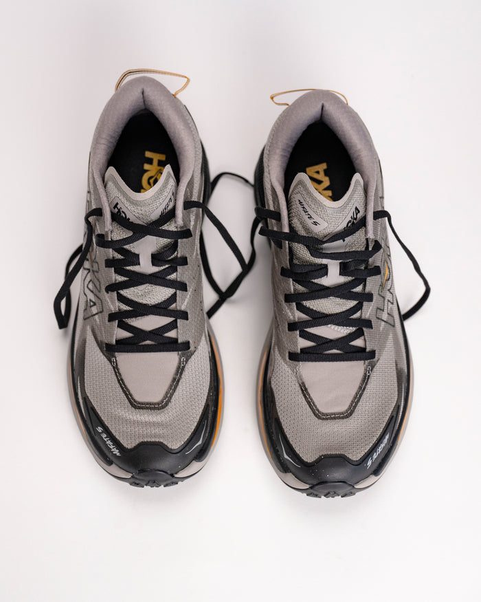 Pair of HOKA Mafate 5 max-cushion trail running shoe with black laces on a white background