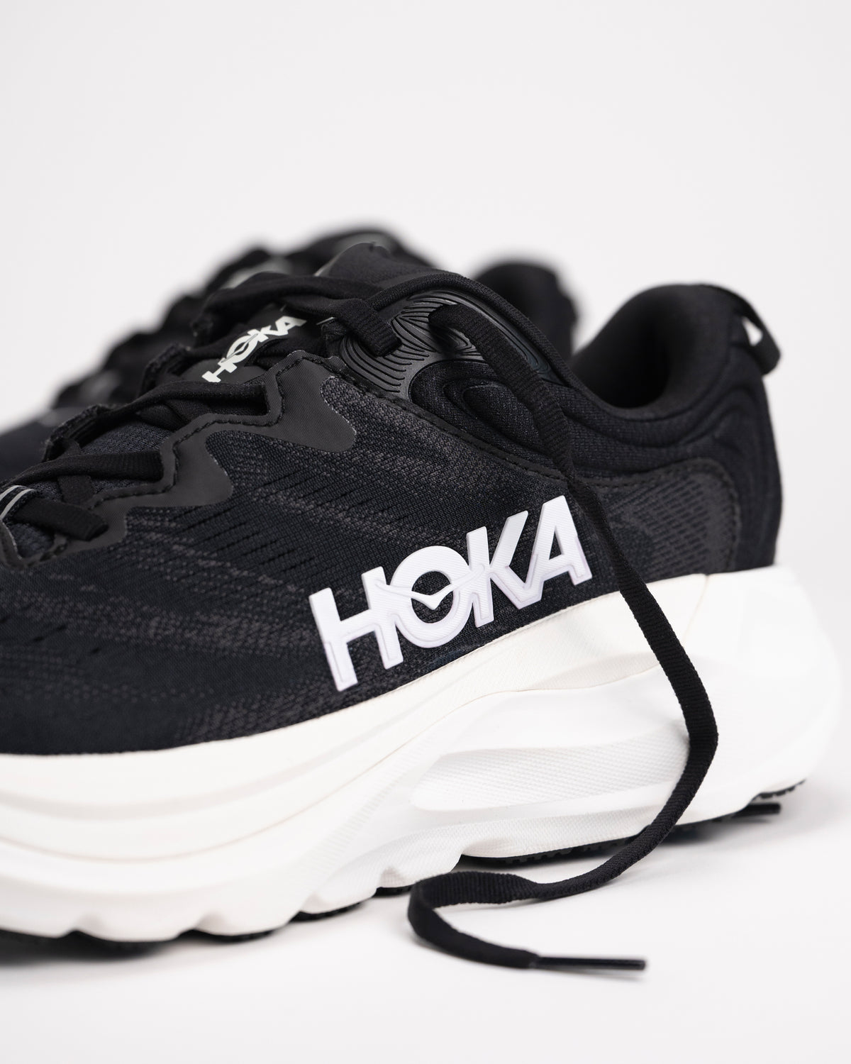 Angled view of HOKA Gaviota 6 running shoes in Black/White highlighting cushioned platform and stable base
