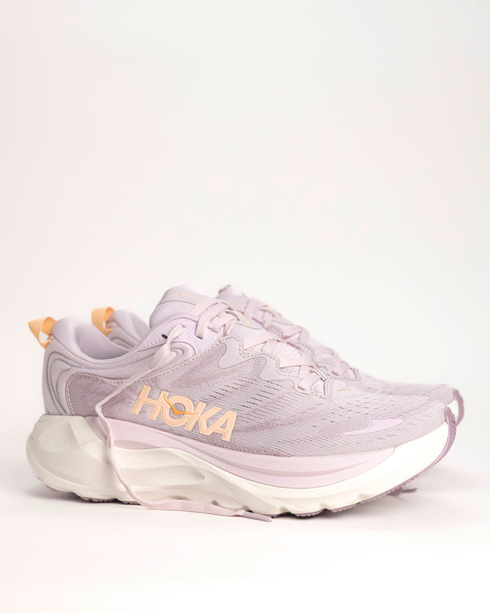 The Women’s HOKA Gaviota 6 is designed for runners and walkers who want dependable stability paired with plush, confidence-building comfort. Built on a broad, cushioned platform, this supportive road running shoe delivers a smooth, balanced ride that feels steady underfoot without feeling stiff or restrictive. Lilac Cream / Fragrant Lilac