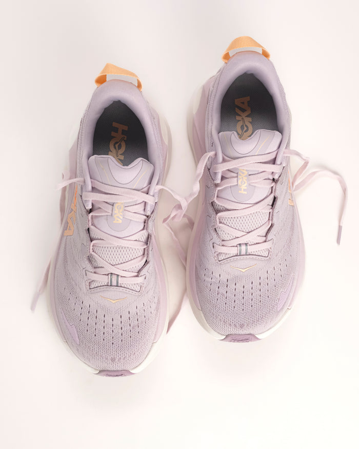 The Women’s HOKA Gaviota 6 is designed for runners and walkers who want dependable stability paired with plush, confidence-building comfort. Built on a broad, cushioned platform, this supportive road running shoe delivers a smooth, balanced ride that feels steady underfoot without feeling stiff or restrictive. Lilac Cream / Fragrant Lilac