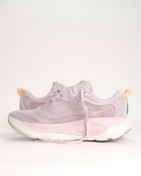 The Women’s HOKA Gaviota 6 is designed for runners and walkers who want dependable stability paired with plush, confidence-building comfort. Built on a broad, cushioned platform, this supportive road running shoe delivers a smooth, balanced ride that feels steady underfoot without feeling stiff or restrictive. Lilac Cream / Fragrant Lilac