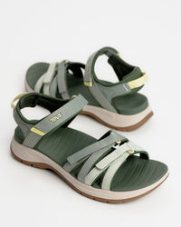 Women’s Teva Tirra Sport Hiking Sandal - Modernized Trail Comfort in Seagrass / Green with Spider Rubber outsole for grip on wet surfaces. Quick dry webbing straps with hook and loop adjustment.