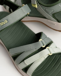 Women’s Teva Tirra Sport Hiking Sandal - Modernized Trail Comfort in Seagrass / Green with Spider Rubber outsole for grip on wet surfaces. Quick dry webbing straps with hook and loop adjustment.