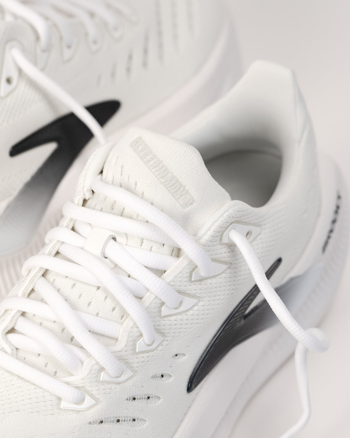 Lace-up and tongue detail shot of the Brooks Glycerin Max 2 lightweight cushioned shoe in White/Chateau Gray/Black 