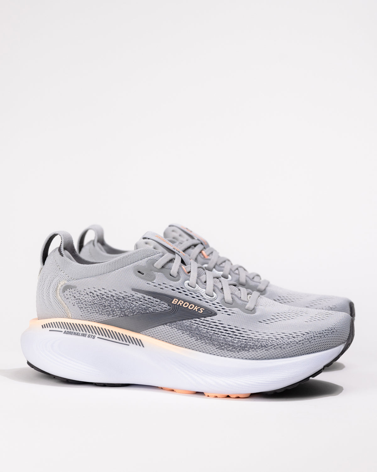 Women’s Brooks Adrenaline GTS 25 in Grey/Coral – medial side showing breathable mesh upper and GuideRails® support system
