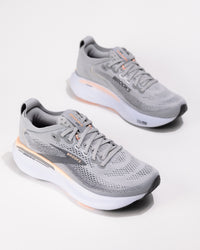 Dynamic angle of the Brooks Adrenaline GTS 25 in Grey/Coral with coral accents and logo