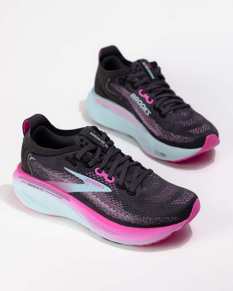 Dynamic angle of the Brooks Adrenaline GTS 25 in Black/Pink with coral accents and logo