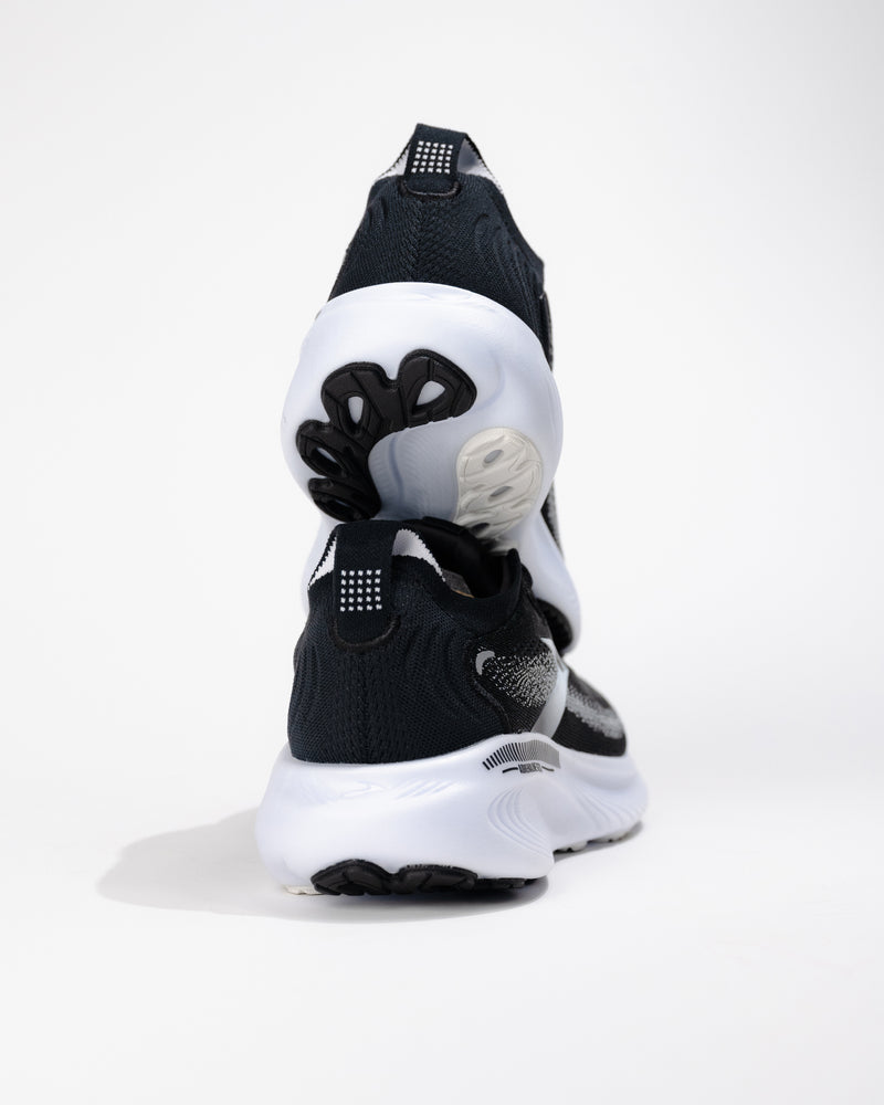 Rear view of Brooks Adrenaline GTS 25 in Black/White highlighting heel counter stability and upper texture