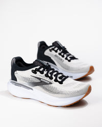 Three-quarter angle of Women's Brooks Adrenaline GTS 25 in White/Black/Gum, highlighting dual-density foam midsole and streamlined silhouette.