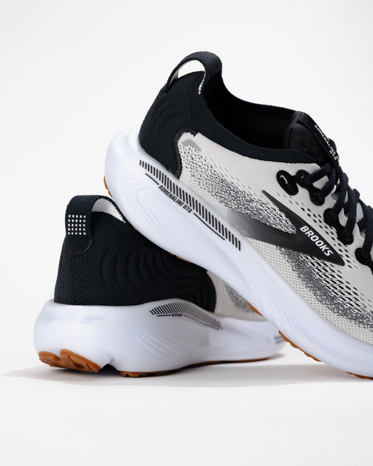 Side view of the Brooks Adrenaline GTS 25 running shoe showing mesh construction and subtle stability support through midsole.