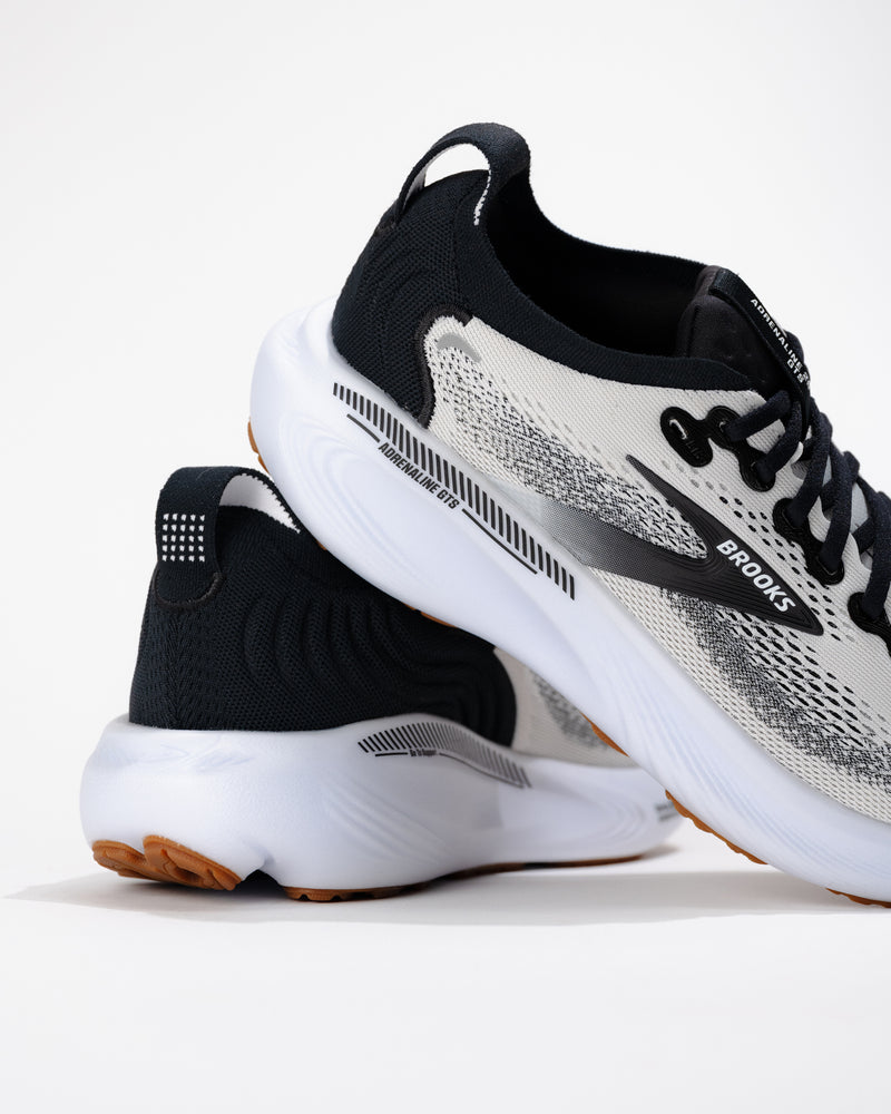 Side view of the Brooks Adrenaline GTS 25 running shoe showing mesh construction and subtle stability support through midsole.