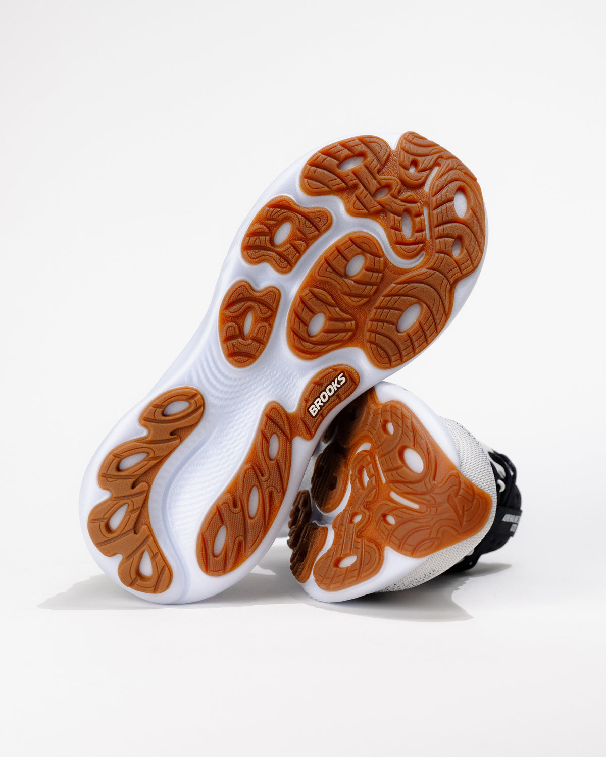 Underside sole of Brooks Adrenaline GTS 25 displaying durable gum rubber traction pattern engineered for road running grip.