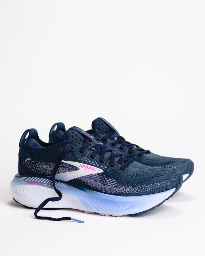 Pair of blue women's Brooks Adrenaline 25 GTS stability running shoes with a light colored sole on a light background