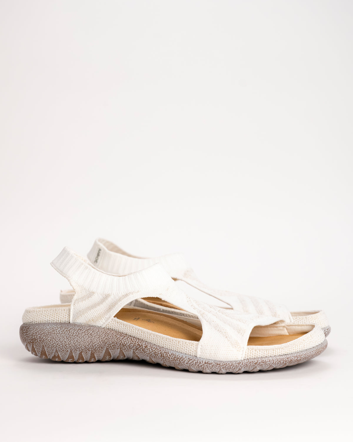 Women’s Naot Kawhia knit slip-on vegan sandal in white with gold sparkle side view on white background