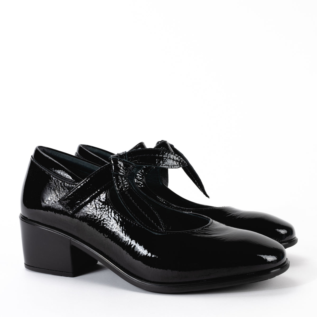 Side view of the Nobility Mary Jane shoe in black patent leather, showing the low, block heel and the slightly curved silhouette of the shoe