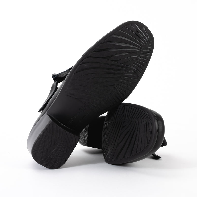 Bottom view of the Nobility Mary Jane shoe in black smooth leather, showing the heel's structure and the textured TPU grippy sole.