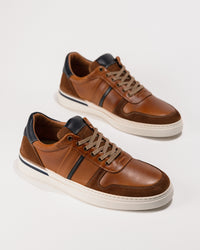 Clean side profile highlighting the tri-color leather upper and low-profile sole in the Brown/Navy Naot Swift sneaker.