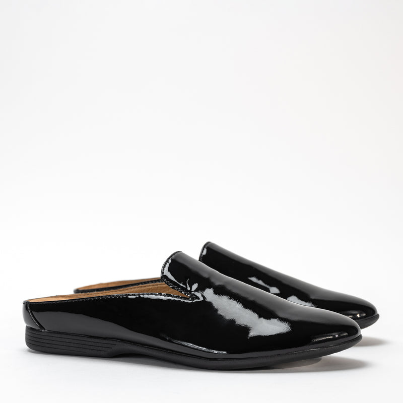 Side view of Dansko Lexie mule in black patent leather, highlighting sleek design and low heel.