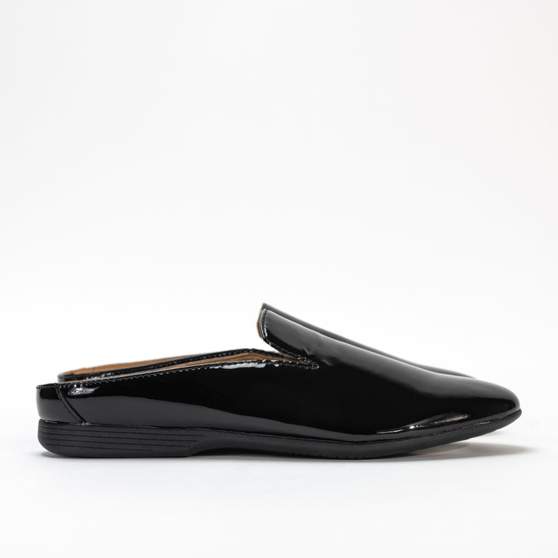 Side view of Dansko Lexie mule in black patent leather, highlighting sleek design and low heel.