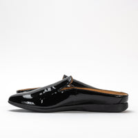 Side view of Dansko Lexie mule in black patent leather, highlighting sleek design and low heel.