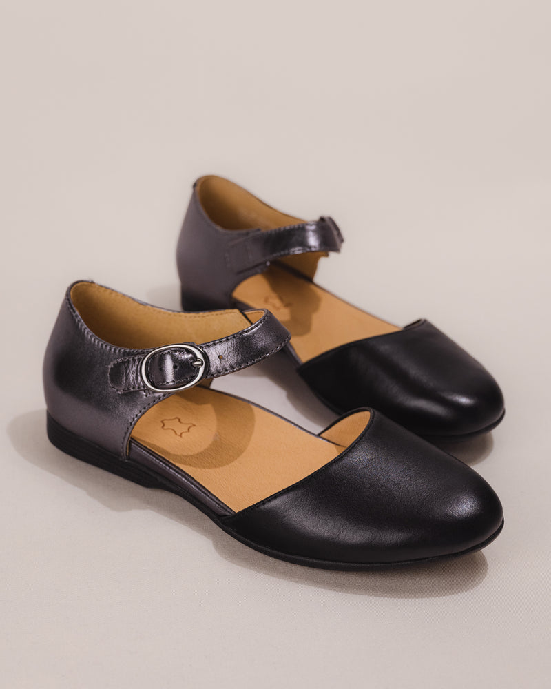 Angled front image highlighting the shine of the pewter metallic leather and curved silhouette.
