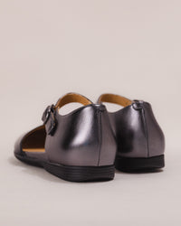 Rear image displaying the gently contoured heel and smooth leather finish.