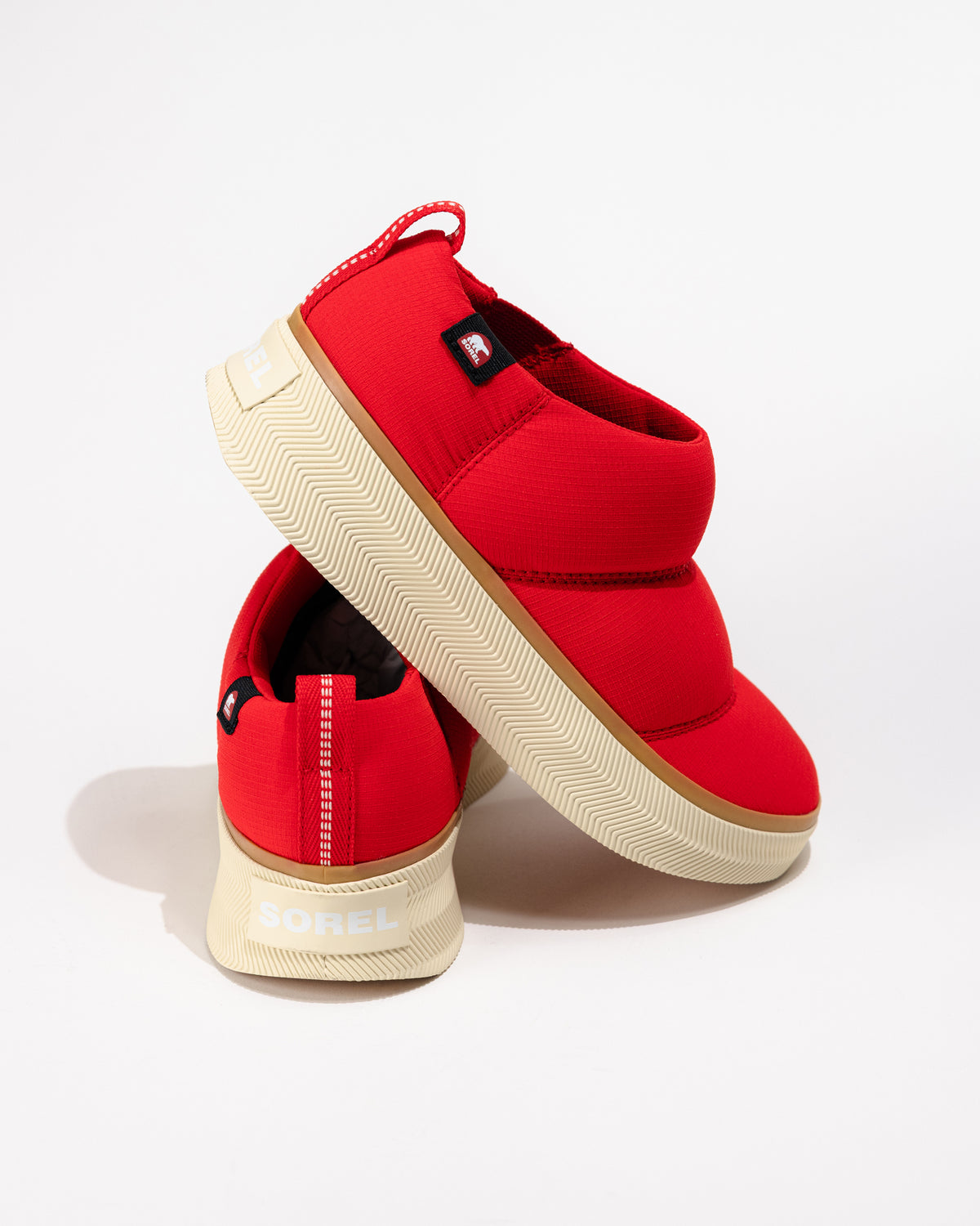 Close-up of the side and heel showing layered puffy design and outsole texture.