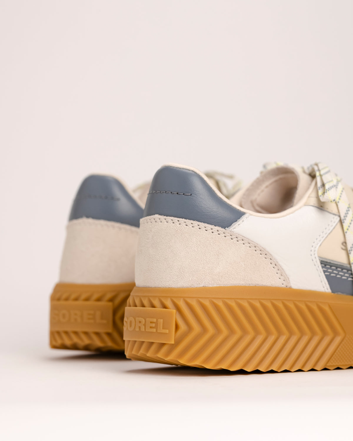 Pair of SOREL Ona Ave T-Toe sneakers with a focus on the platform sole and SOREL logo against a light background