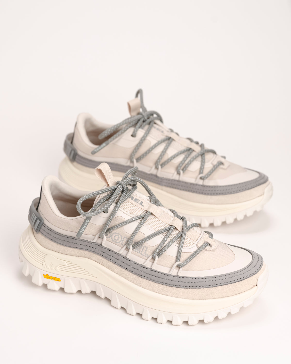 Pair of white and gray SOREL Callsign Horizon™ Low Sneaker in Fawn / Chrome Grey on a light background
