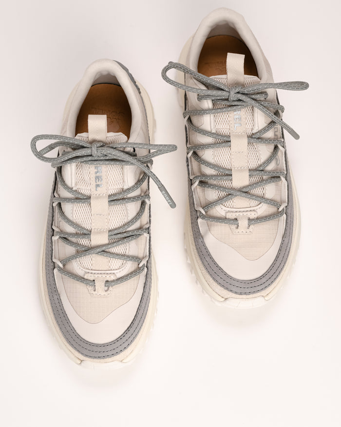 Overhead view of a pair of white SOREL Callsign Horizon™ Low Sneaker in Fawn / Chrome Grey with gray laces on a light background