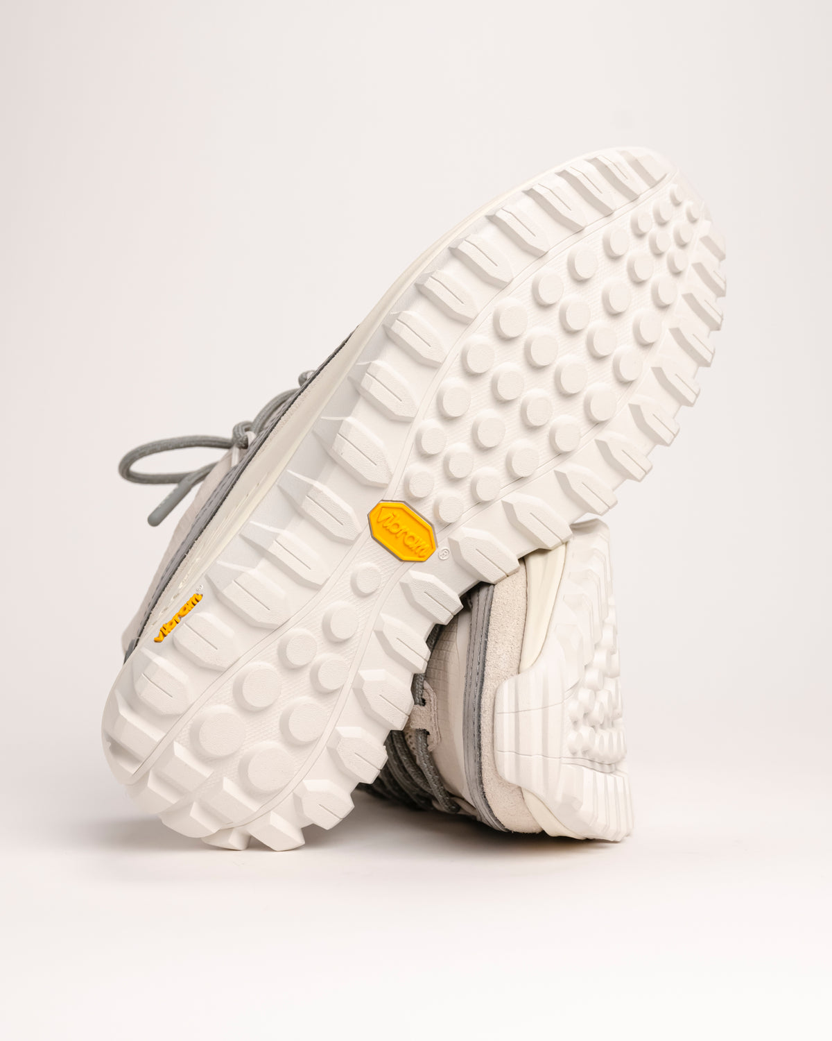 Close-up of white Vibram XS TREK EVO outsole of SOREL Callsign Horizon Low  on a light background