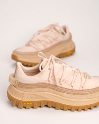 Pair of peach and tan SOREL Callsign Horizon™ Low sneakers with brown soles on a light background
