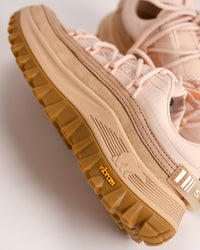 Peach pink SOREL Callsign Horizon™ Low sneaker with brown Vibram sole on a light background