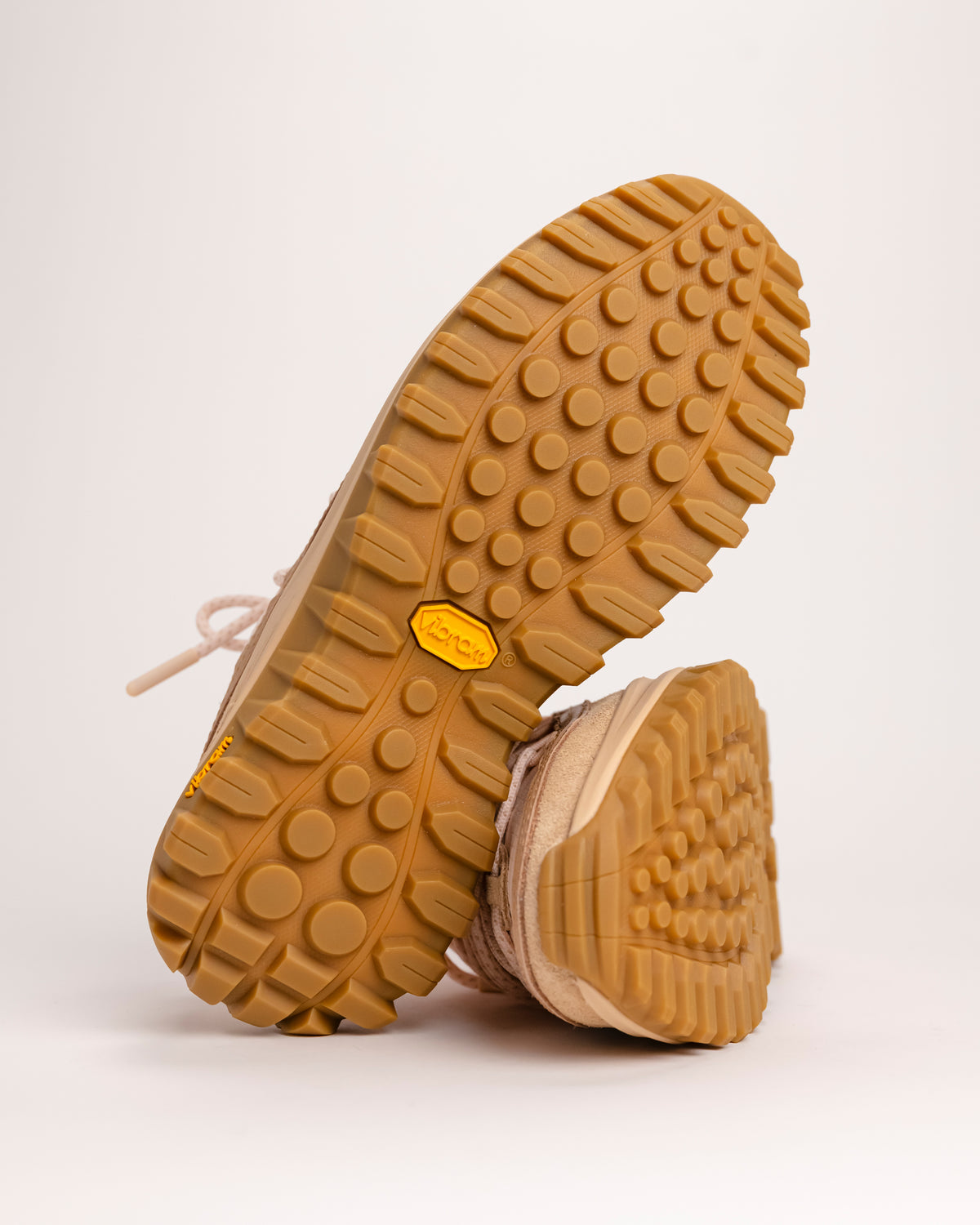 Close-up of the sole on a SOREL Callsign Horizon™ Low shoe for off-road shoe with a visible Vibram brand logo on a light background