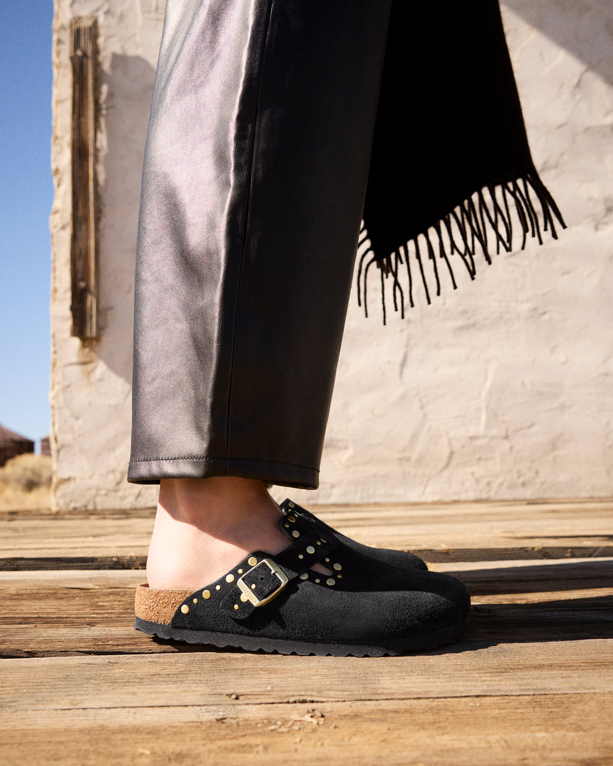 View of the outer side strap with metal buckle and rivet accents.