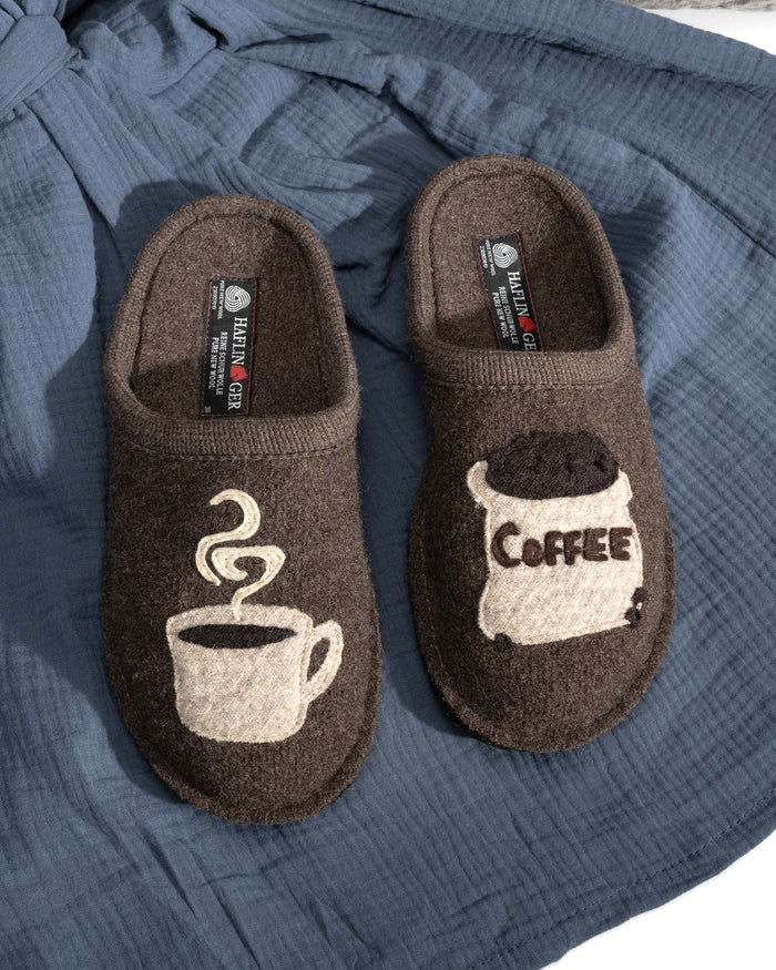 Brown Haflinger boiled wool slippers with coffee-themed design on a blue fabric background 313039-63