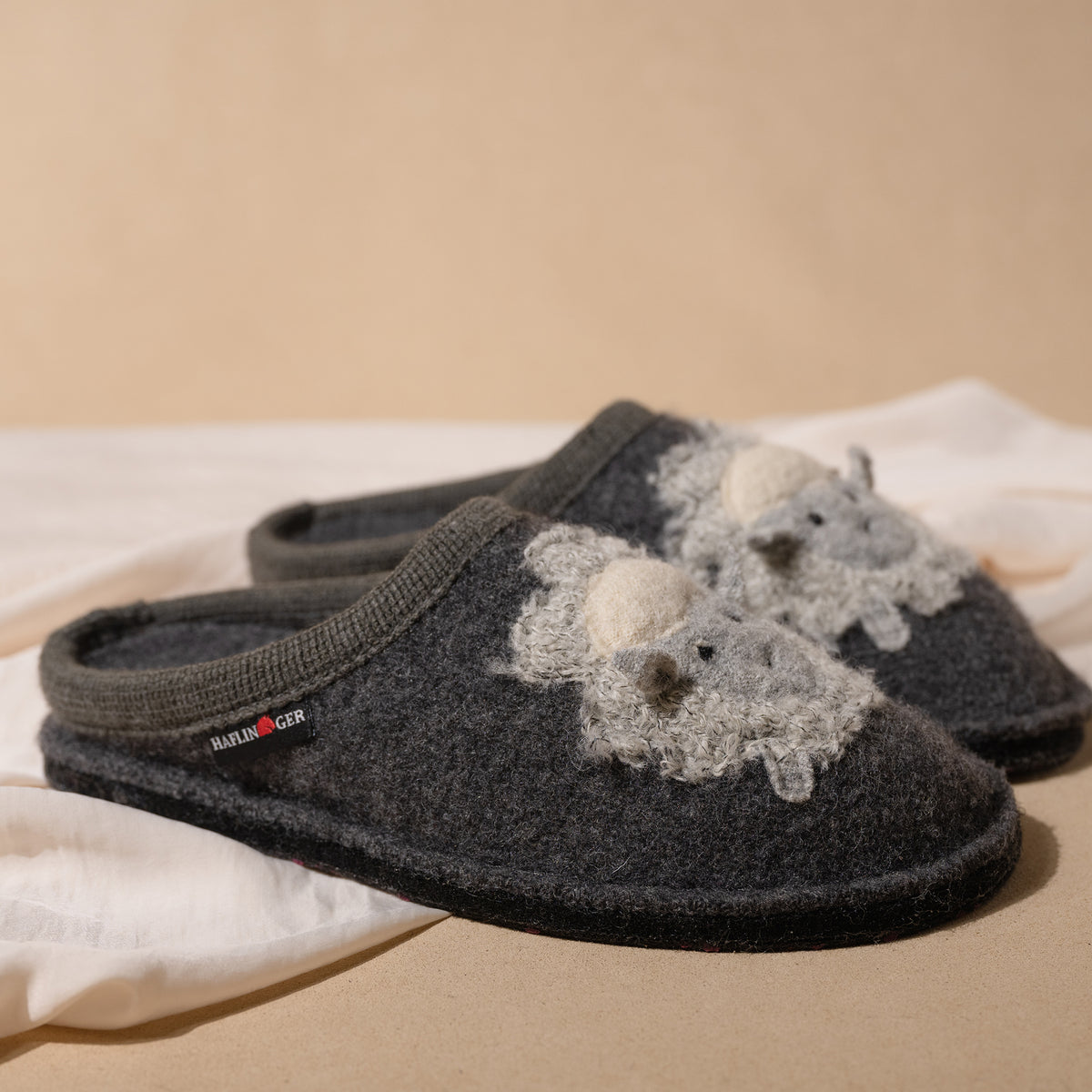 Profile view of the Women's Haflinger Lamby Soft and Cozy Wool Slipper in Gray showing dimensional lamb applique.