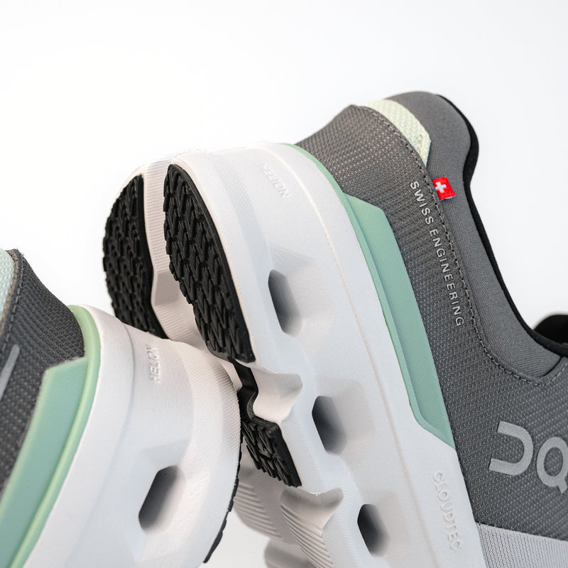 Detailed heel view of the Men's On Running Cloudrunner 2 in Glacier / Sage / White, showing the Helion superfoam midsole detail.