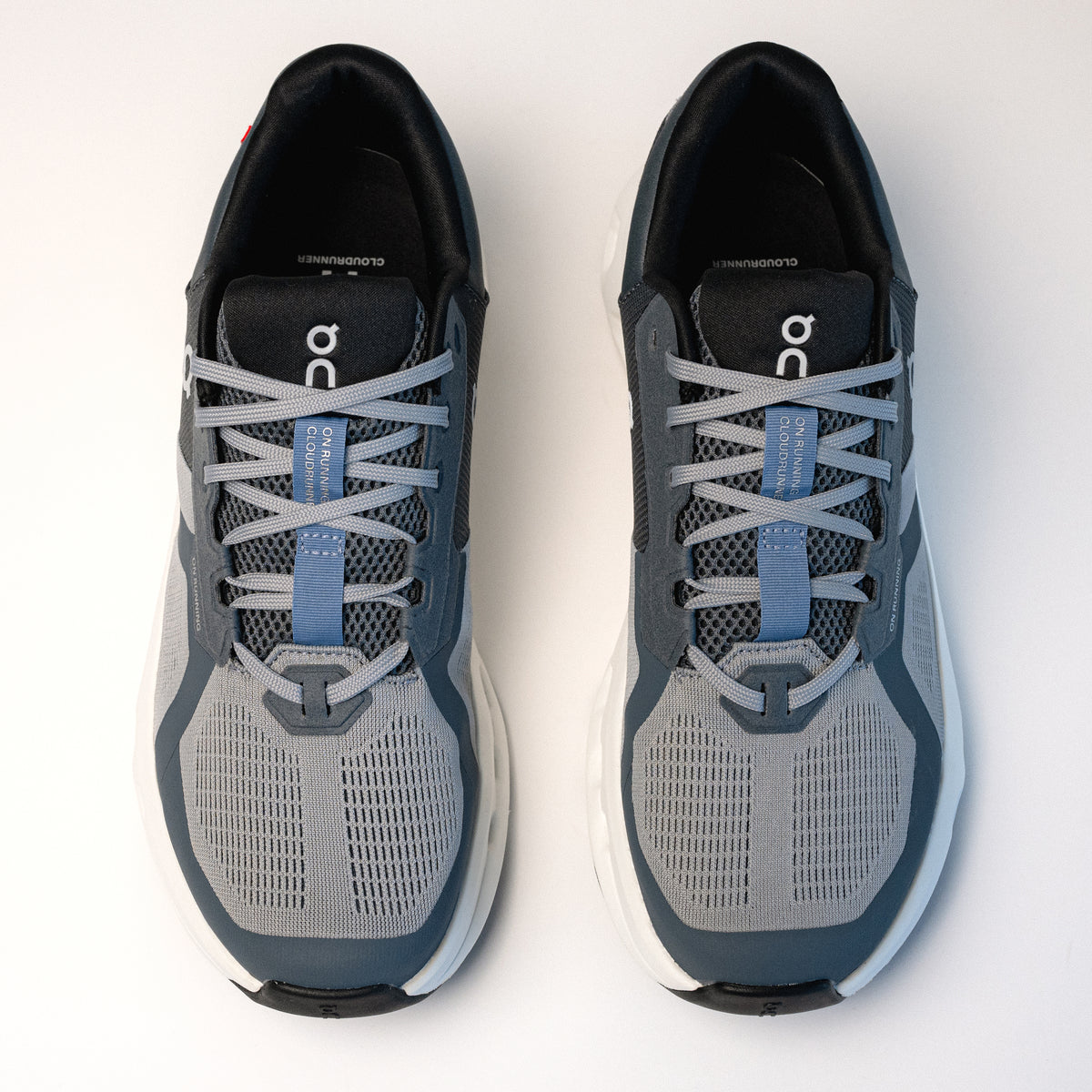 Overhead lace and heel cap view of the Men's On Running Cloudrunner 2 in Alloy / Chambray