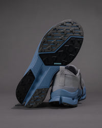 Gray and blue athletic shoe with sole detail on a gray background
Men's On Cloudsurfer Trail 2 in Rock/Niagara – Plush Cushioning Trail Running Shoe