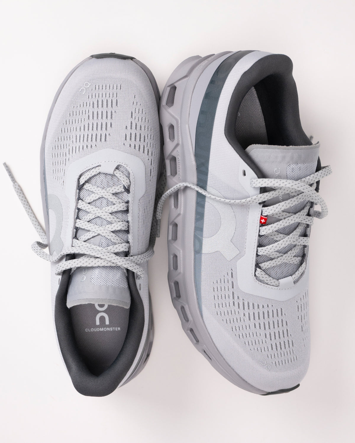 Gray Men’s On Cloudmonster 1 running shoes with light gray laces on a light white background