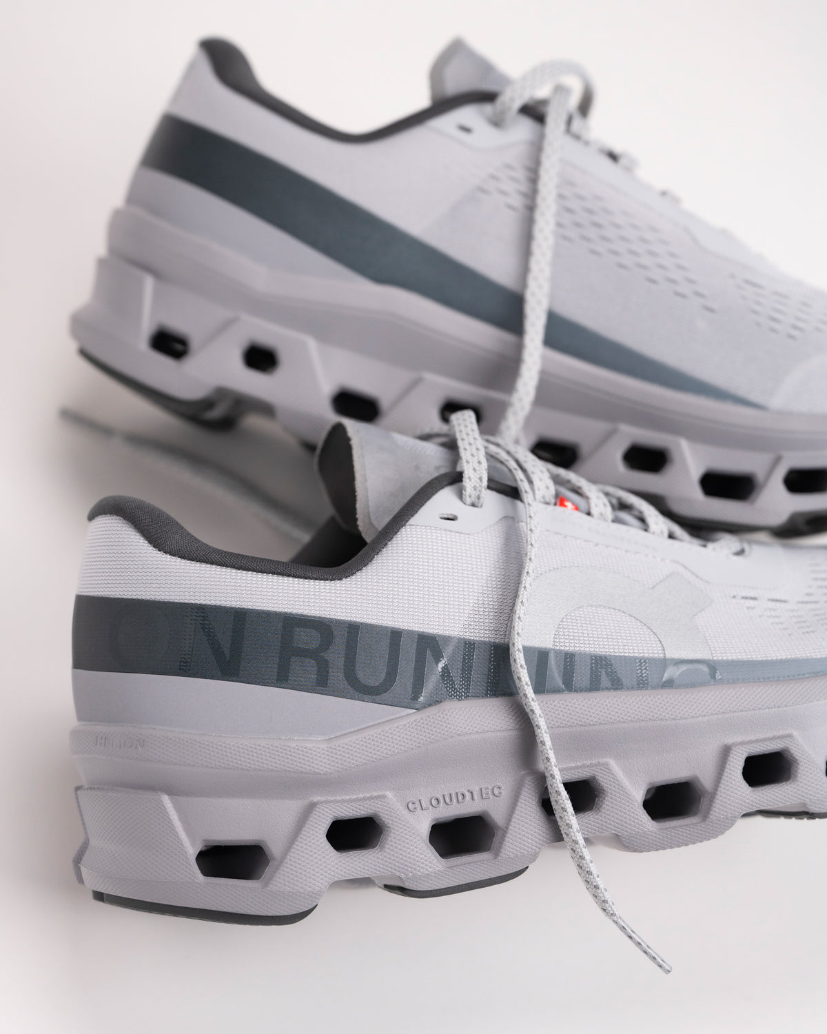 Heel view of Men’s On Cloudmonster 1 Glacier/Alloy showing structured cushioning and support